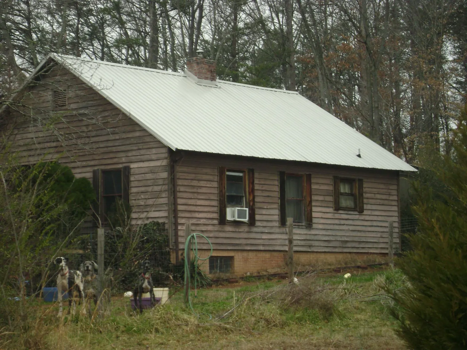 White metal roof on an old wood sided farmhouse, from a Metal Roof Installation job in Millerton